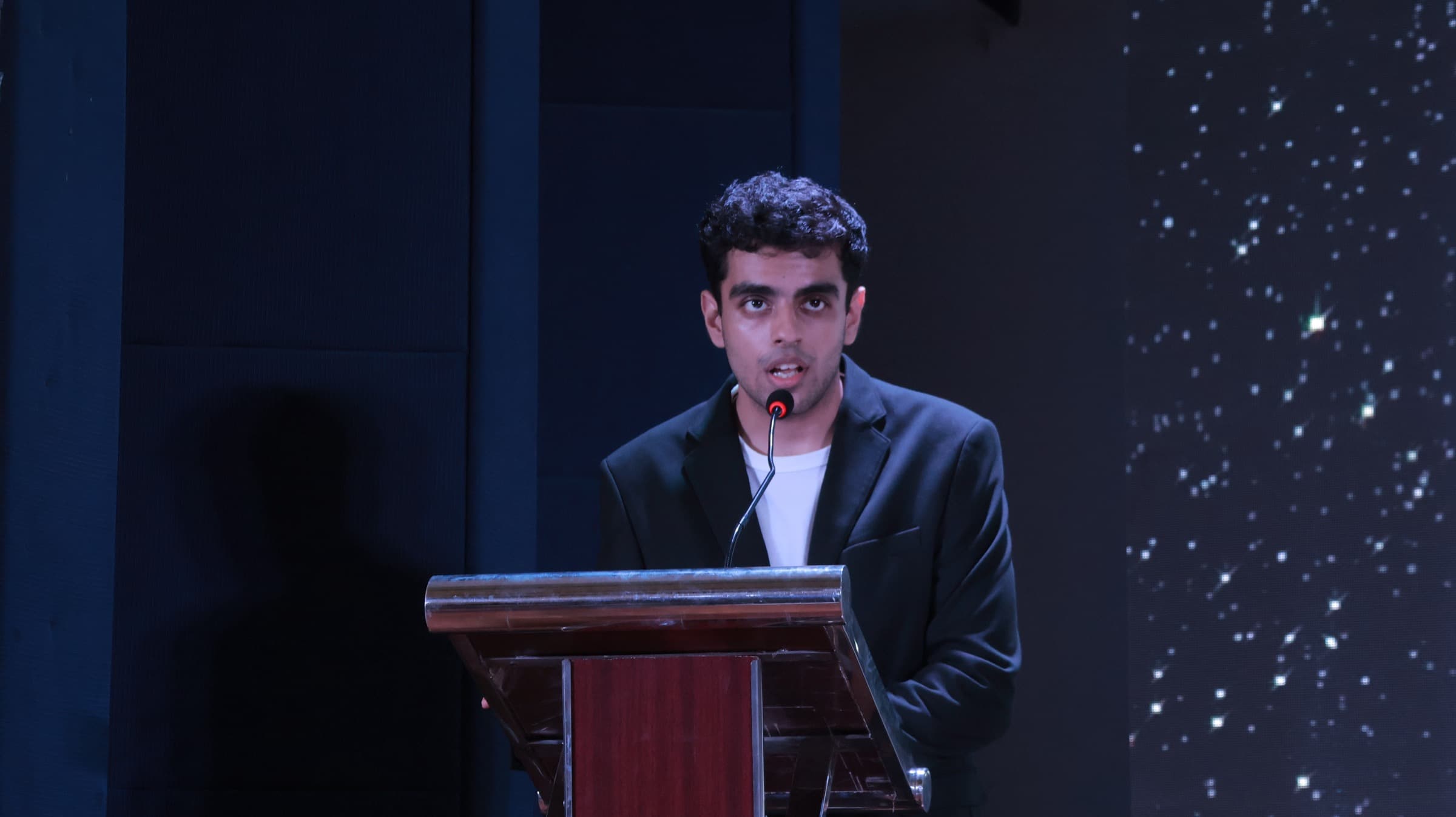 Tanay speaking on stage
